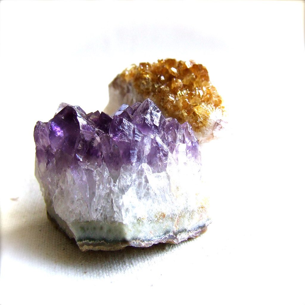 Amethyst next to citrine-colored crystals